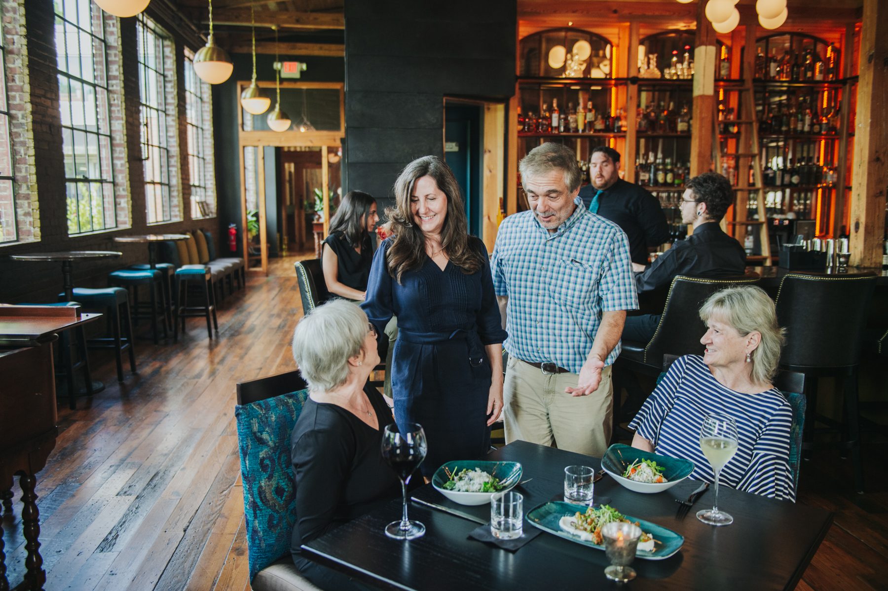 Greg Lewis and Maria Parker-Lewis, owners of The Sycamore at Chatham Mills who saw the pandemic impact their opening plans, stand and talk to customers.