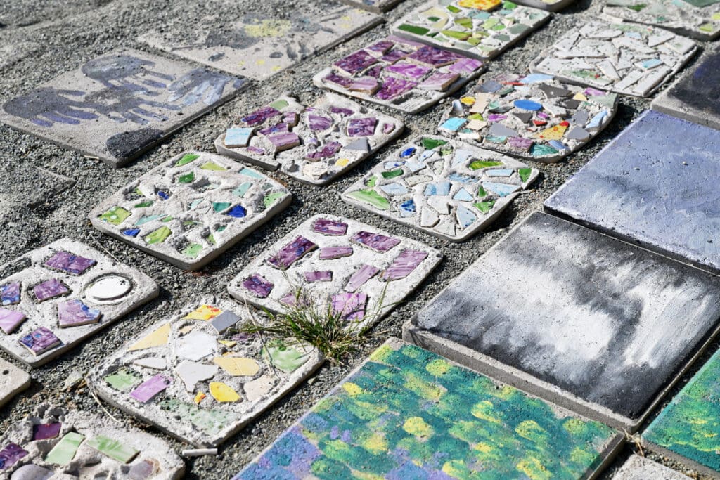 Students create mosaic tile walkway outside Chatham Middle School under the direction of teaching artist in residence Jessica Rigsbee