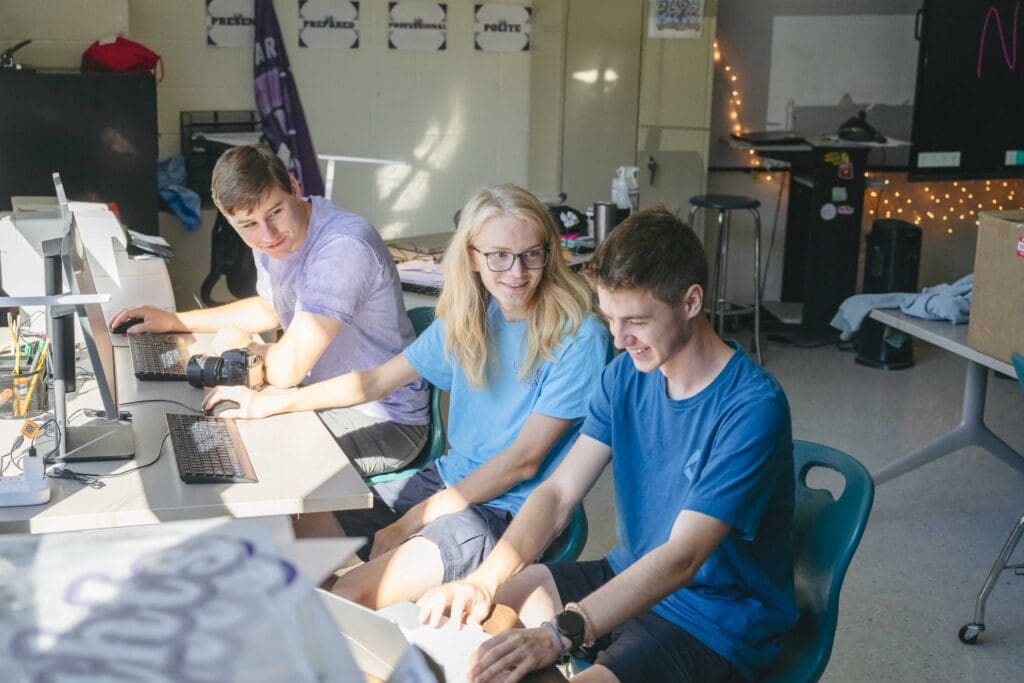 Chatham Charter DECA students edits photos for their business, Castle Media.