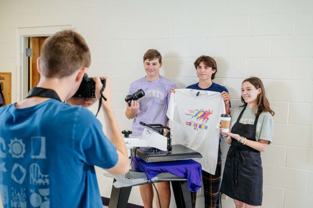 Chatham Charter DECA's Adam Reese capturing student business leaders on camera.