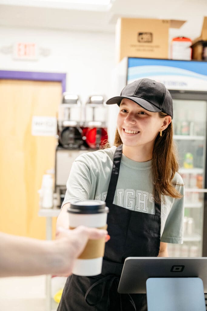 Chatham Charter DECA student Tori serves coffee from her student-run business.