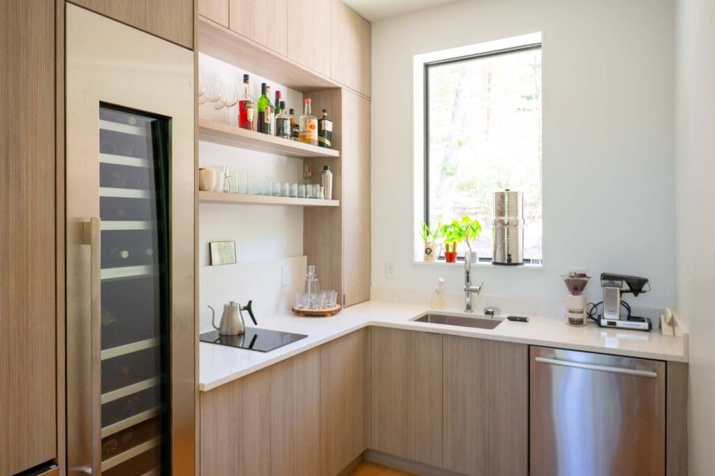 A kitchenette area of the home offers a coffee and cocktail station. 