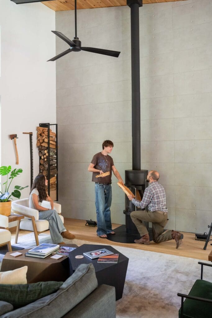 Jason's son, Carter, helps his dad start a fire in the living room's woodburning fireplace. 