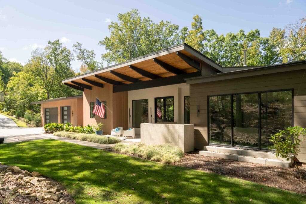 The exterior of the home showcases its unique architecture amongst the natural scenery.