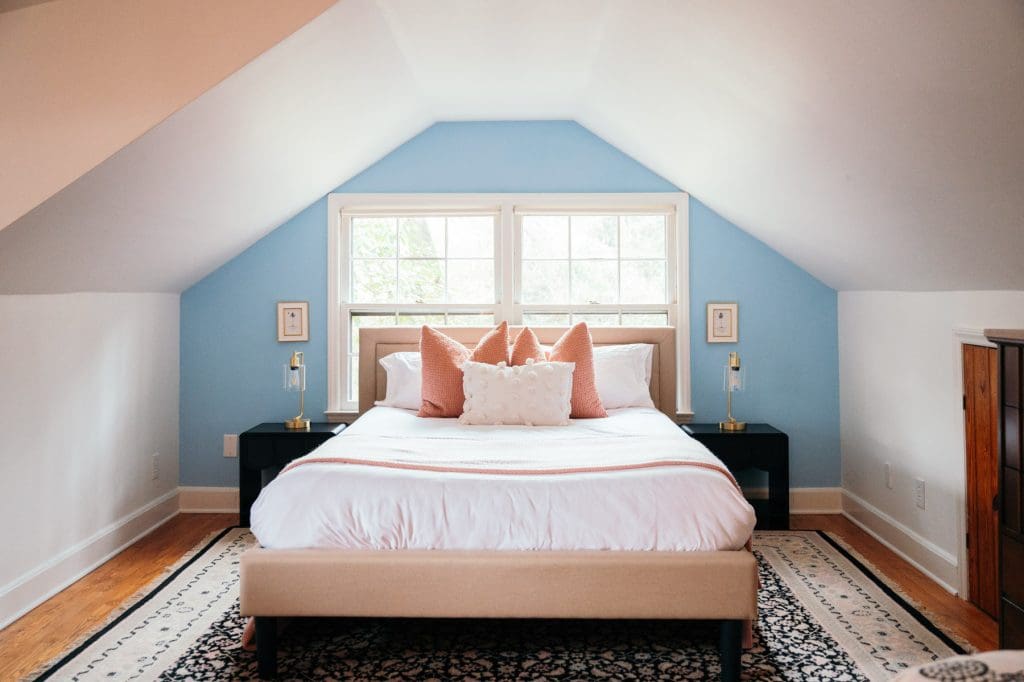 The upstairs bedroom of the Loblolly House offers a comfortable, inviting bed for guests. 