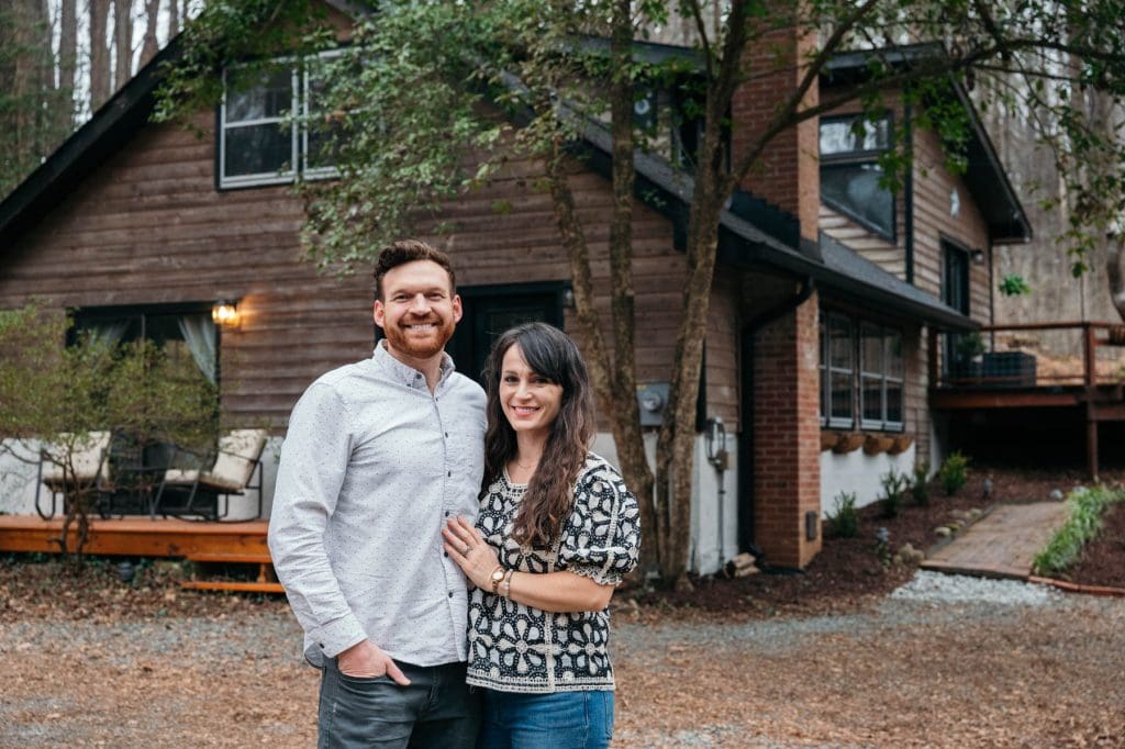 A Chatham County couple stand in front of their Airbnb retreat in Briar Chapel, Loblolly House.