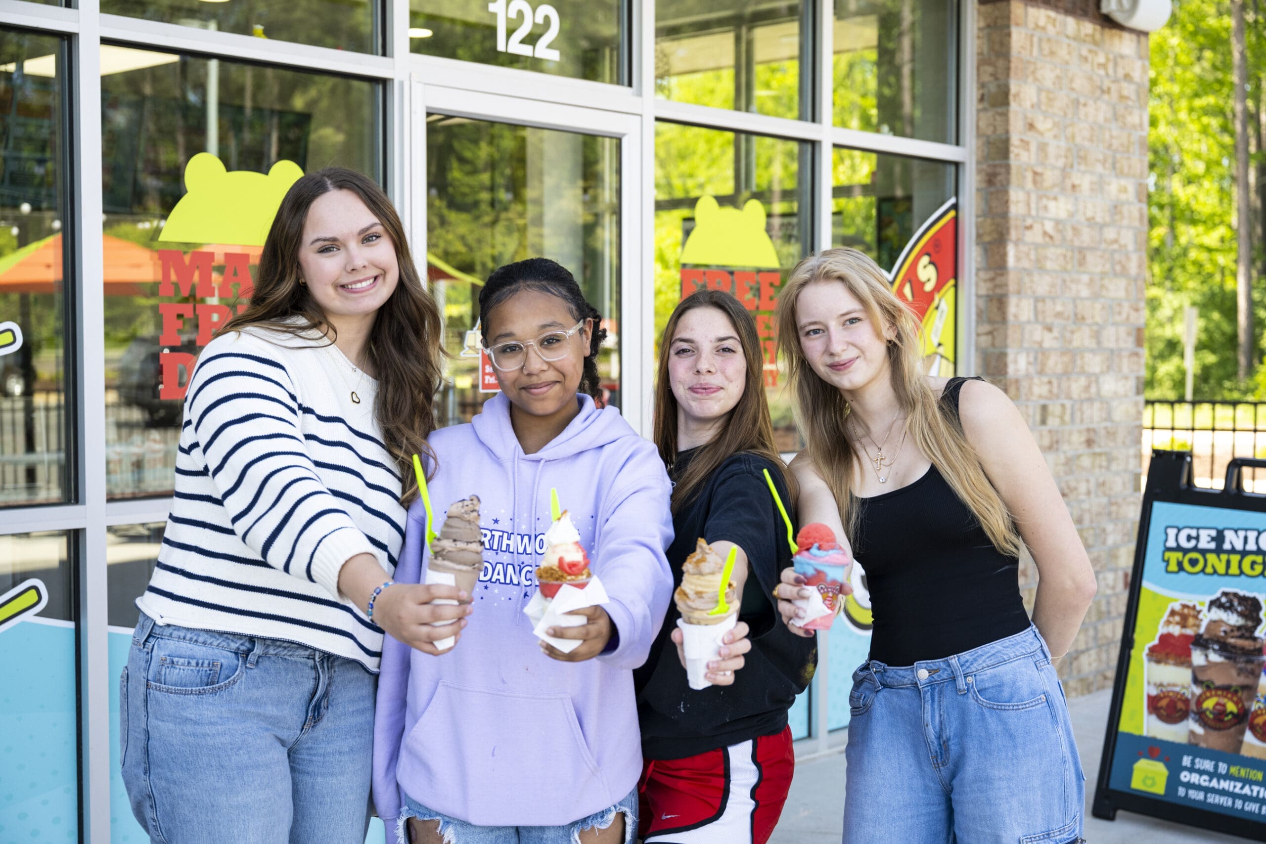 Mah'Kya McNeill, Sophia Herbst, Cadence Zigenfuss and Chloe Waldstein smile at the camera while holding shave ice and custard from Jeremiah's Italian Ice.