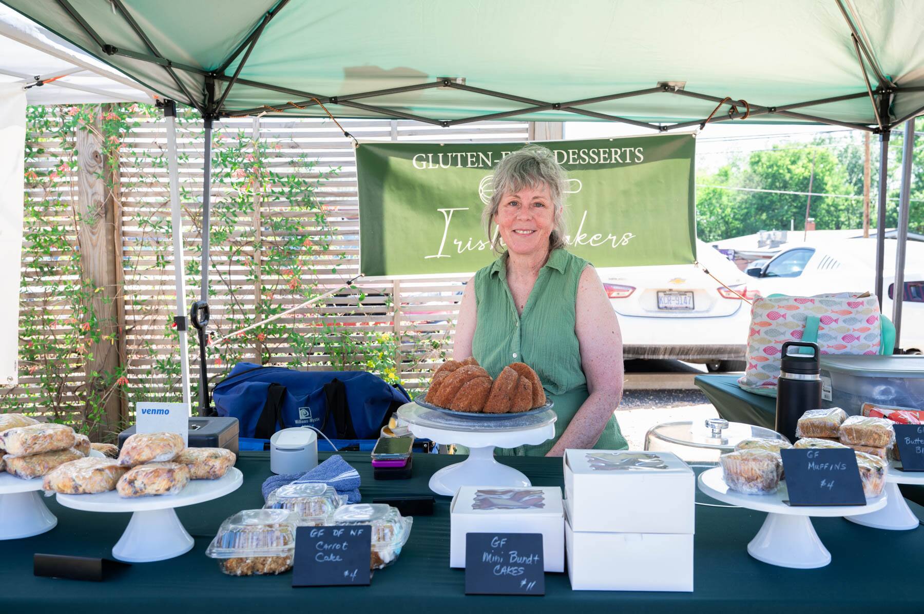 Mary O'Loughlin of Irish Bakers poses for a portrait in her tent at the Pittsboro Farmer's Market. 