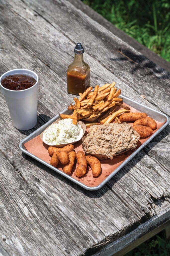 Best of Chatham winner Allen & Son Bar-B-Cue spread featuring hushpuppies, fries, cole slaw and barbecue. 
