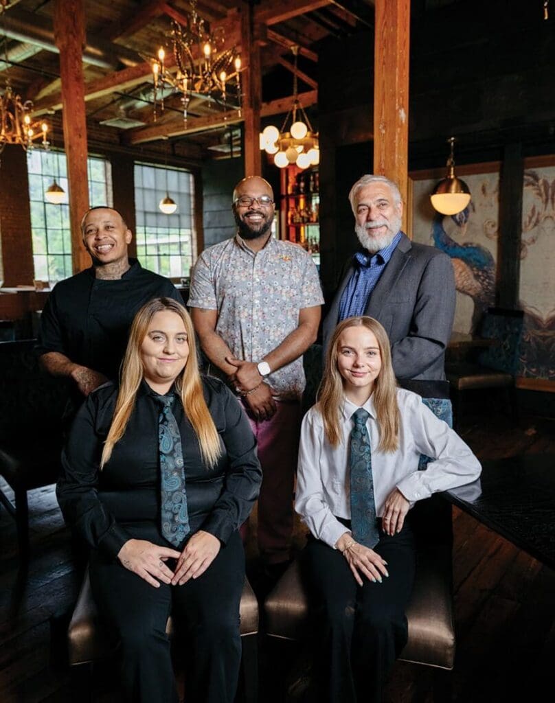 Members of staff at The Sycamore at Chatham Mills, Executive chef Ernest Fisher, general manager
Delfiscio Herring, owner Greg Lewis, bar manager
Tabitha Mattson and lead server Katelyn Riddle, smile for their photo as one of Chatham County's best restaurants. 