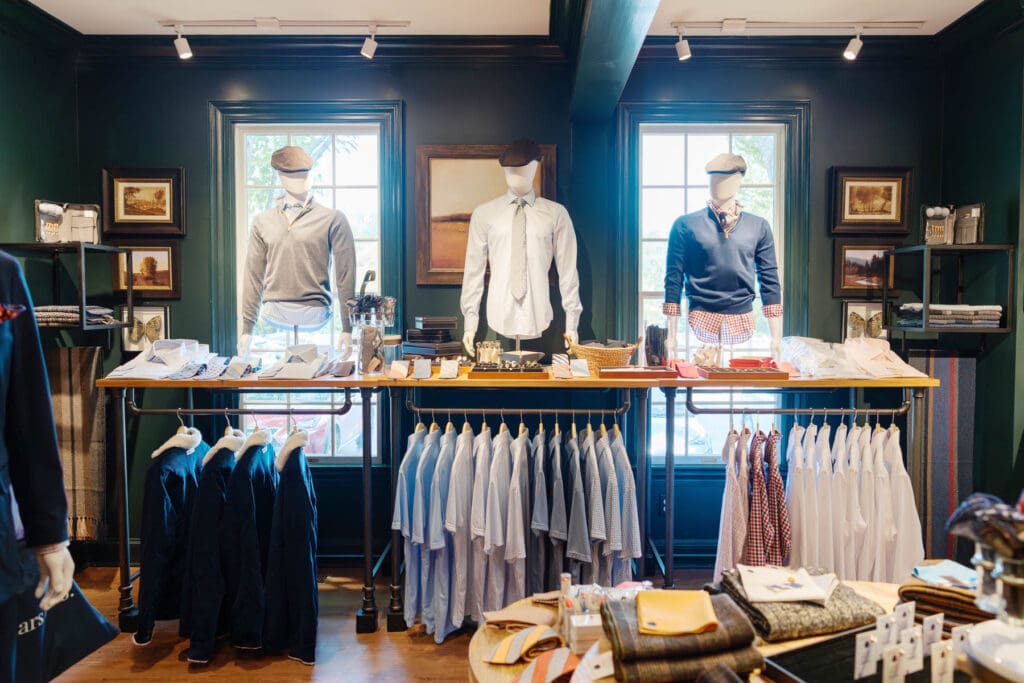 Racks of men's clothes in shop.