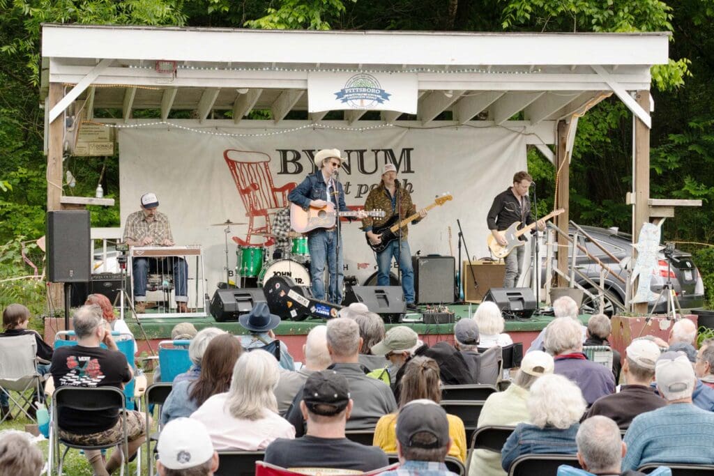 Folks sit gathered at a concert.